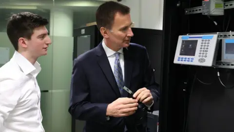 PA Jeremy Hunt creates a "cyber attack" during a visit at the University of Glasgow.