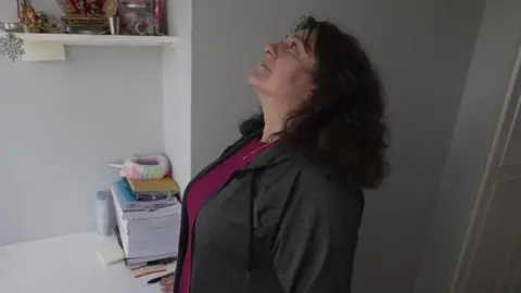 Alison Johnson inspecting damage