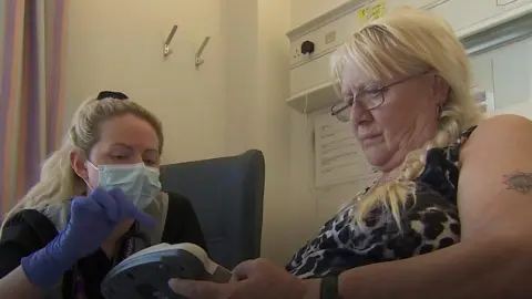 Health care professional with patient in hospital