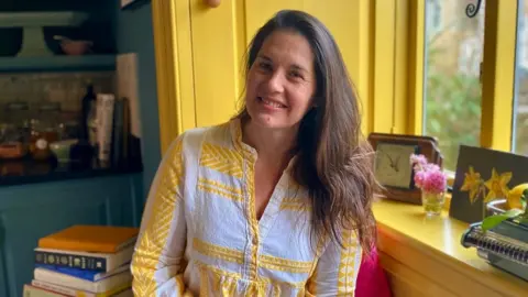 BBC Laura Leaver sitting in her kitchen