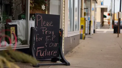 Getty Images Photo of a sign outside a business in East Palestine that says 'Please pray for E.P. and our future."