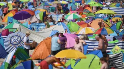 Getty Images People crowded on to the beach at Zinnowitz on the island of Usedom in the Baltic Sea, northern Germany