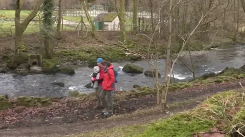 CRKC People walking along the River Kent bank near the Staveley water treatment works overflow pipe