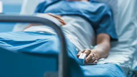 A patient lying in a hospital bed