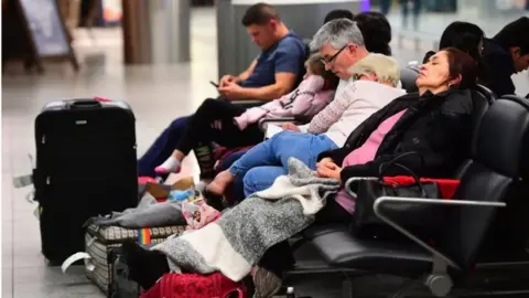 PA People sleeping at Gatwick