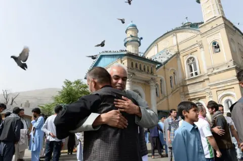 AFP Afghan Muslims hug each other after offering prayers at the start of the Eid al-Fitr holiday which marks the end of Ramadan at the Shah-e Do Shamshira mosque in Kabul on June 15, 2018