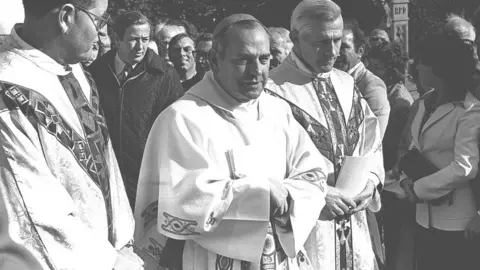 Pacemaker Archbishop of Armagh Tomás Ó Fiaich (centre) outside Armagh Cathedral in 1977