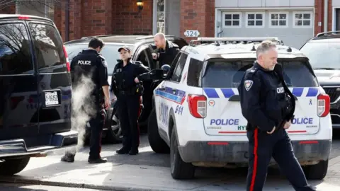 Reuters Ottawa Police Service officers surround a home after four children and two adults were found dead inside a neighbouring house in the Ottawa suburb of Barrhaven, Ontario, Canada