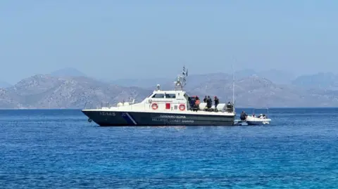 BBC A Hellenic Coast Guard vessel in the sea near a coast