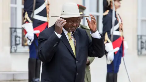 Getty Images President Yoweri Museveni of Uganda wearing a hat on a visit to France