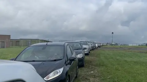 Gabbi Osborne Cars in traffic jam at boardmasters