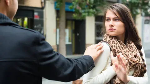 Getty Images Woman being harassed