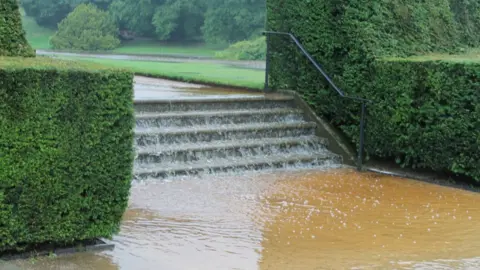 NT Water cascading down the steps in the garden at Lyme Park