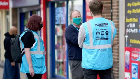 Getty Images Kirklees coronavirus response team members talk to the public in Dewsbury town centre on May 27, 2021 in Dewsbury, England.