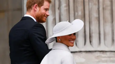 Reuters Prince Harry and Meghan, Duchess of Sussex, arrive for the National Service of Thanksgiving