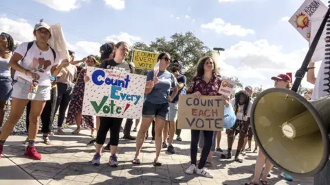 EPA A crowd of protesters demand a vote recount outside the Miami-Dade Election Department in Florida, 10 November 2018