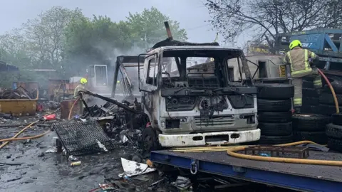 West Midlands Fire Service Burnt-out truck in fire