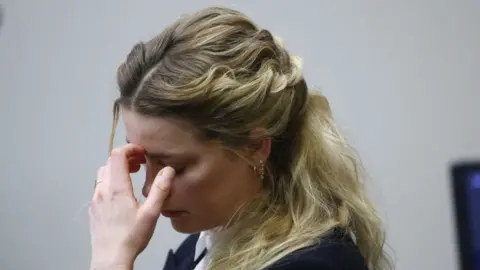 Getty Images Amber Heard reacts to an audio recording played in court