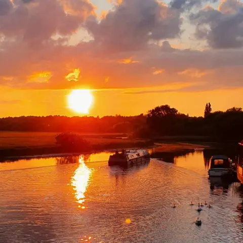 Paul Harper-Harris The sun setting over narrowboats in St Ives, Cambridgeshire