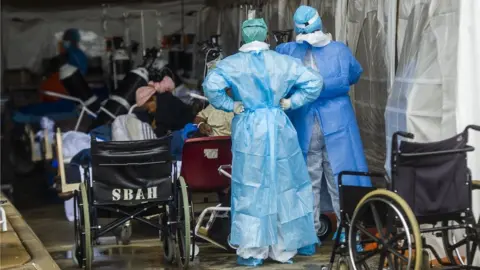 Getty Images Health care workers and patients outside area Steve Biko Academic Hospital in Pretoria, South Africa.