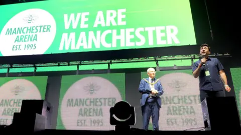 Getty Images Andy Burnham (right) at the reopening of Manchester Arena in September 2017