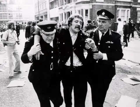 St John Ambulance An injured man is helped by volunteers
