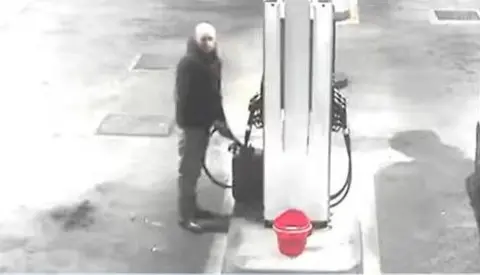 CPS CCTV image of Calum Sunderland filling a petrol canister at a petrol station.