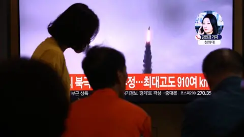 Getty Images People watch a TV showing a file image of a North Korean missile launch at the Seoul Railway Station on October 02, 2019 in Seoul,