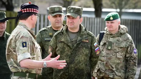 MOD British Army Colonel Charlie Wallace speaking to Russian officers