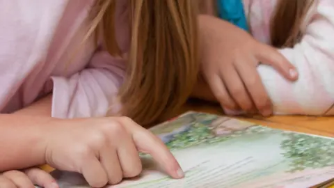 Thinkstock Schoolchildren looking at a book