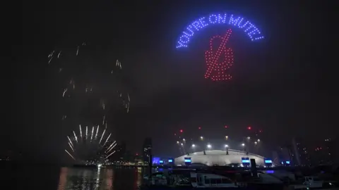 PA Media Fireworks and drones illuminate the night sky over London as they form a light display as London"s normal New Year"s Eve fireworks display was cancelled due to the coronavirus pandemic.