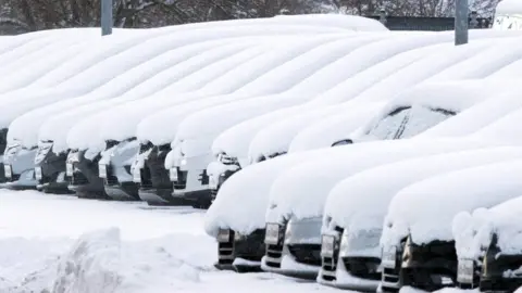 AFP A thick blanket of snow lies on cars at a used car dealer in Rehna, Germany