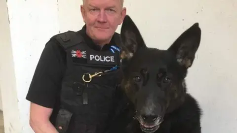 PA/West Mercia Police PC Davey in uniform with Bacca