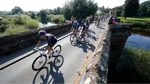 Martin Rickett/PA Wire Cyclists crossing bridge in Wales