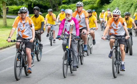 Getty Images Satwant Singh takes part in The Queen's Baton Relay as it visits Bradford