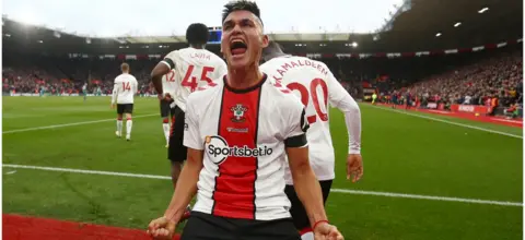 Getty Images Carlos Alcaraz of Southampton celebrates after scoring during the Premier League match between Southampton FC and Wolverhampton Wanderers at St. Mary's Stadium on February 11, 2023 in Southampton, England.