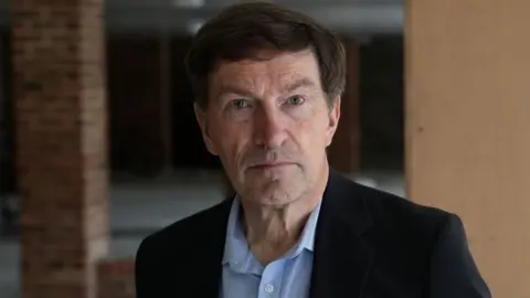 John Fairhall/BBC Portrait of councillor Paul Smith who says some of the residents were not entitled to help