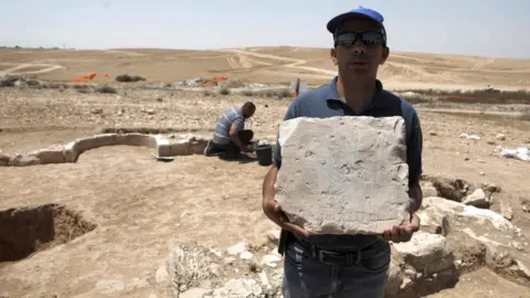 Getty Images A worker from Israel's Antiquities Authority at the site of an ancient mosque