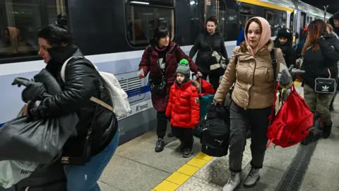 Getty Images Ukrainian refugees arriving at the train station in Rzeszow in Poland