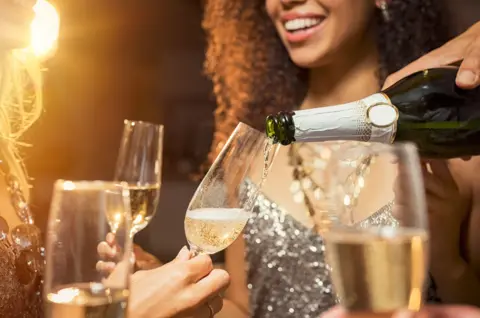 Getty Images Workers drinking champagne