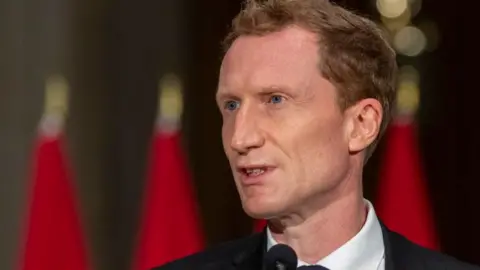 AFP via Getty Images Minister of Crown-Indigenous Relations Marc Miller speaks during a press conference in Ottawa, Canada, in October 2021