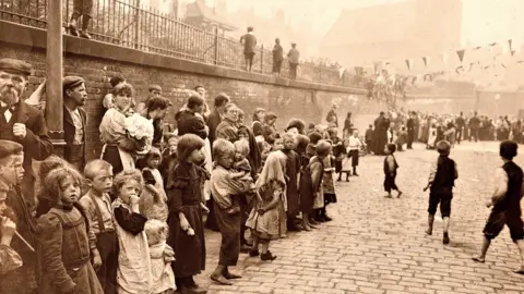 Supplied Children outside the Charter Street Mission in the 1800s