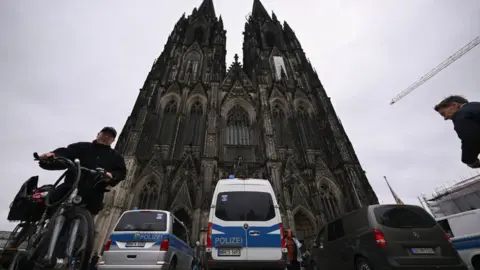 AFP Police cars stand in front of the Cologne Cathedral