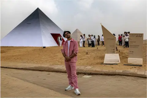 AFP Man standing in front pf pyraminds