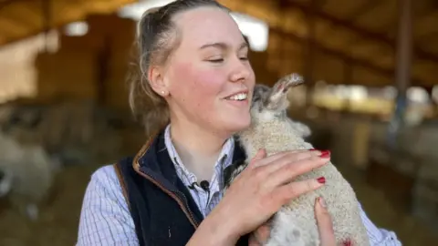 Martin Giles/BBC Libby Lawrence delivering a lamb