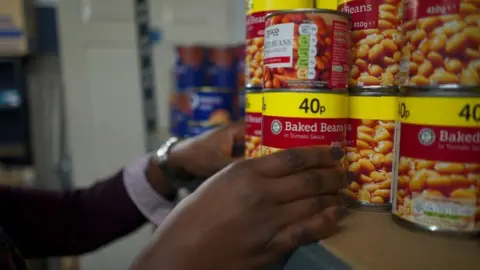 Jamie Moreland/BBC Baked beans on a shelf