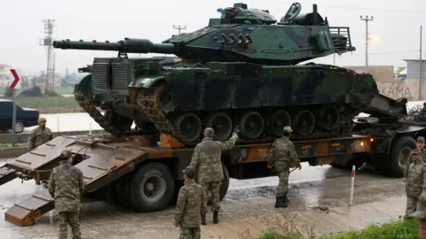 Reuters A Turkish tank arrives at an army base in the border town of Reyhanli