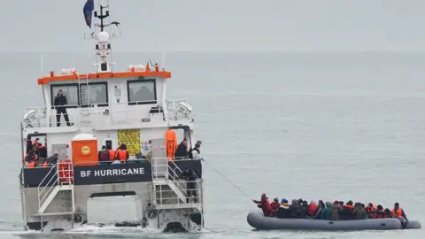 PA Media A group of people thought to be migrants are rescued off the coast of Folkestone, Kent, by a Border Force vessel