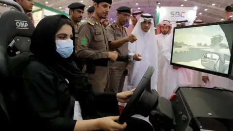 EPA A woman uses a driving simulator in Riyadh (13 May 2018)