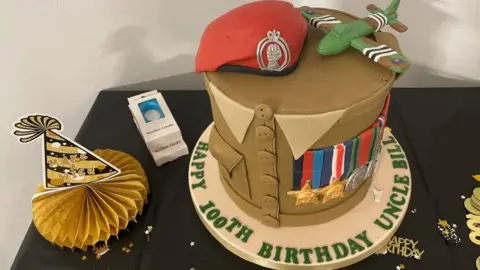 PA Media A birthday cake in the shape of an Army uniform